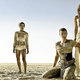 The women of Mad Max: Fury Road stand together on the very dry land of the world.